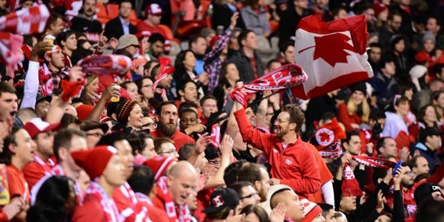 Nov 13, 2015; Vancouver, British Columbia, USA; Canadian fans celebrate during the second half in a FIFA World Cup qualifier soccer match at BC Place. Canada won 1-0. Mandatory Credit: Anne-Marie Sorvin-USA TODAY Sports