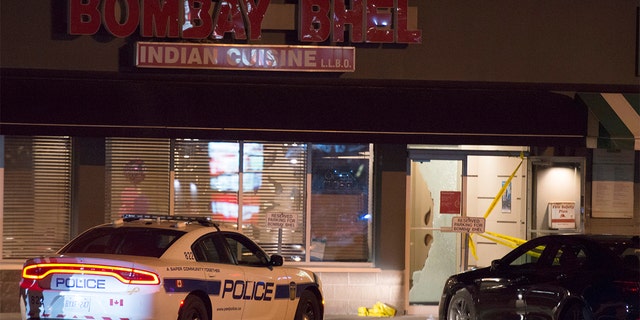 Police standing outside the Bombay Bhel restaurant in Mississauga, Canada on Friday.