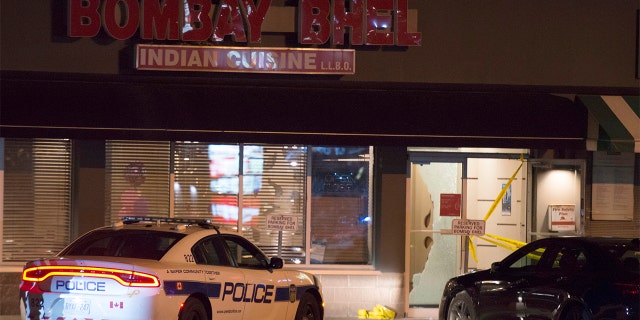 Police standing outside the Bombay Bhel restaurant in Mississauga, Canada on Friday.