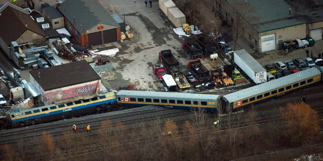 Feb. 26, 2012: Emergency crews work the scene of a Via Rail train derailment in Burlington, Ontario, west of Toronto.