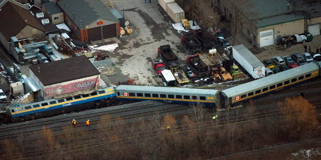 Feb. 26, 2012: Emergency crews work the scene of a Via Rail train derailment in Burlington, Ontario, west of Toronto.