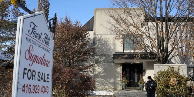 A police forensics photographer works outside the home of billionaire founder of Canadian pharmaceutical firm Apotex Inc., Barry Sherman and his wife Honey, who were found dead under circumstances that police described as "suspicious," in Toronto, Ontario, Canada December 16, 2017.