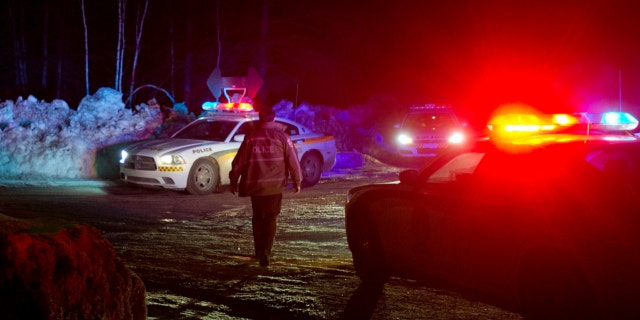 March 17, 2013: Police vehicles block a road just outside the town of Chertsey, Quebec, during a search for escaped prisoners.