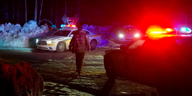 March 17, 2013: Police vehicles block a road just outside the town of Chertsey, Quebec, during a search for escaped prisoners.