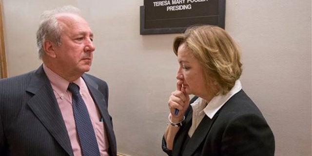 Canadian diplomat Roxanne Dube, right, speaks with attorney Curt Obront outside a courtroom at the Richard E. Gerstein Justice Building, Thursday, Feb. 4, 2016, in Miami. Dube's son, Marc Wabafiyebazu, 15, is charged with murder and other crimes in the March 30, 2015, drug-related South Florida shootout that killed his older brother and another youth. (AP Photo/Wilfredo Lee)