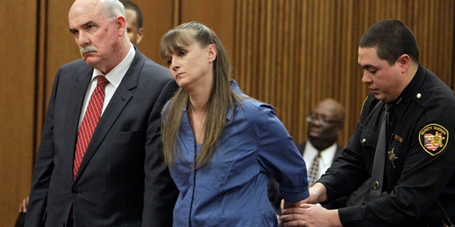 Feb. 16: Monica Hussing, center is handcuffed after being sentenced to eight years in prison on involuntary manslaughter charges in Cleveland.