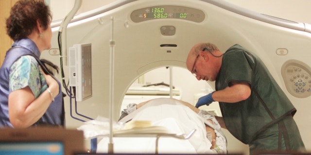 June 3, 2010: Dr. Steven Birnbaum works with a patient in a CT scanner at Southern New Hampshire Medical Center in Nashua, N.H.