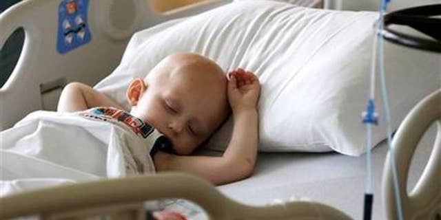 May 22, 2015: Landon Kimich, 2, sleeps as he receives a chemotherapy treatment for neuroblastoma at Houston's M.D. Anderson Cancer Center.