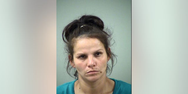 Candie Dominguez, 35, was arrested for murder Oct. 3, 2014 after police found a body wrapped in trash bags at Lopez's residence, where she also lived.