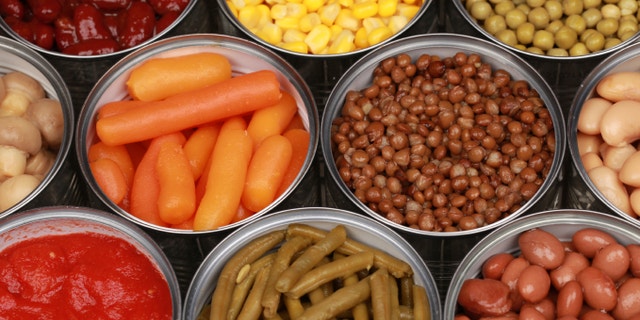 Vegetables such as carrots, lentils, corn, peas and tomatoes in cans