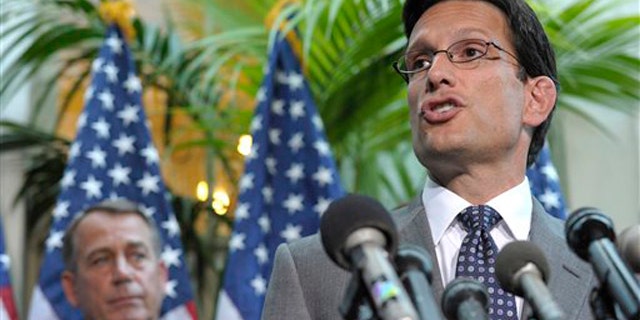 House Majority Leader Eric Cantor, right, accompanied by House Speaker John Boehner, speaks during a news conference on Capitol Hill July 12.