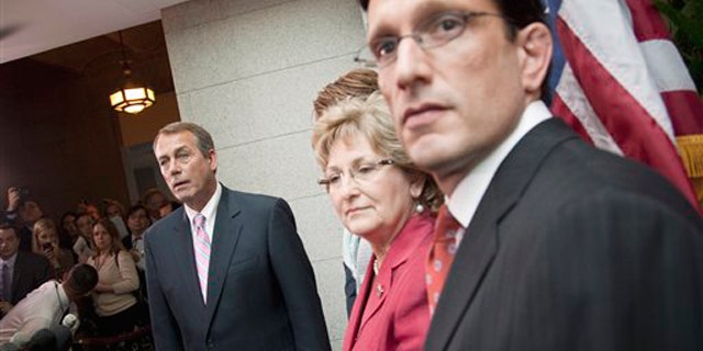House Speaker John Boehner, left, listens to a question during a news conference on Capitol Hill April 15, 2011. From left are, Boehner, Rep. Diane Black, and House Majority Leader Eric Cantor.