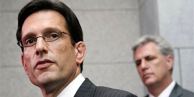 House Majority Leader Eric Cantor, left, accompanied by House Majority Whip Kevin McCarthy, speaks to reporters on Capitol Hill May 3.