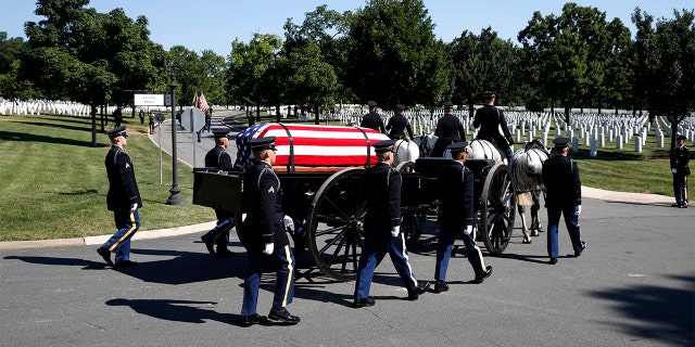 A horse drawn caisson carries the remains of Army Air Force Staff Sgt. John H. Canty, of Winsted, Conn., during his burial service at Arlington National Cemetery on Tuesday.
