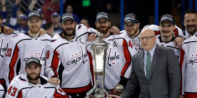 The Washington Capitals pose with the NHL's Eastern Conference championship trophy after eliminating Tampa Bay on Wednesday night.