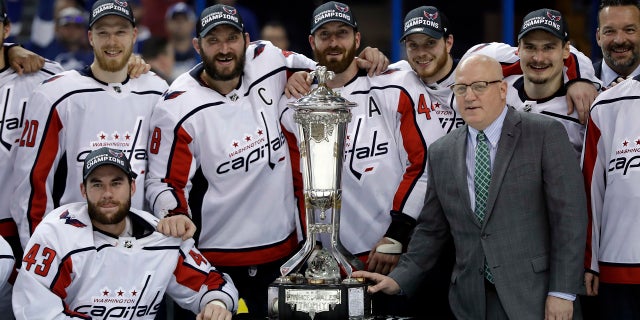 The Washington Capitals pose with the NHL's Eastern Conference championship trophy after eliminating Tampa Bay on Wednesday night.