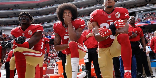 FILE - In this Oct. 2, 2016, file photo, San Francisco 49ers outside linebacker Eli Harold, left, quarterback Colin Kaepernick, center, and safety Eric Reid kneel during the national anthem before the team's NFL football game against the Dallas Cowboys in Santa Clara, Calif. Kaepernick accepted Sports Illustrated's Muhammad Ali Legacy Award from Beyonce on Tuesday night, Dec. 5, 2017, and promised that "with or without the NFL's platform, I will continue to work for the people." Beyonce thanked Kaepernick for his "personal sacrifice," and 2016 Ali Award winner Kareem Abdul-Jabbar called Kaepernick a "worthy recipient" during a video tribute.(AP Photo/Marcio Jose Sanchez, File)