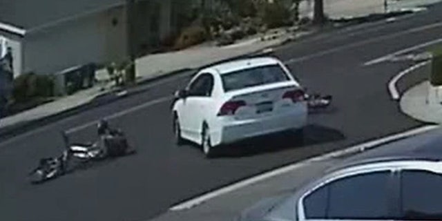 The Honda can be seen striking two children as they ride their bikes last month.