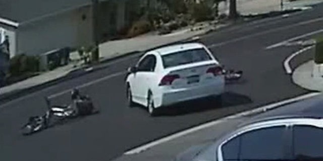 The Honda can be seen striking two children as they ride their bikes last month.