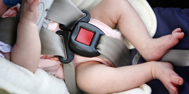 This file photo shows a baby napping in a car seat. 