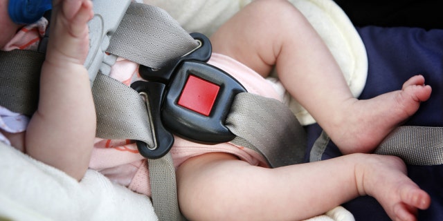 This file photo shows a baby napping in a car seat. 