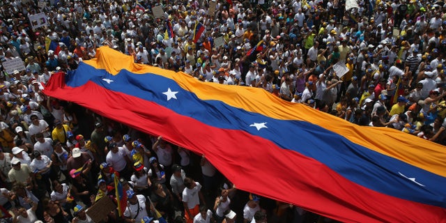 CARACAS, VENEZUELA - MARCH 02: Thousands of protesters march in one of the largest anti-government demonstrations yet on March 2, 2014 in Caracas, Venezuela. Venezuela has one of the highest inflation rates in the world, and opposition supporters have protested for almost three weeks, virtually paralyzing business in much of the country. (Photo by John Moore/Getty Images)