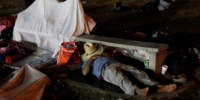 A Central American migrant sleeps after taking a break from traveling in a caravan during a journey to the U.S., at a sports field in Matias Romero, Oaxaca, Mexico April 3, 2018.