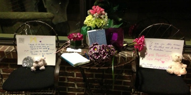 July 17, 2013: This image shows flowers and notes left near the site where an 11-month-old girl died after being locked inside an SUV.