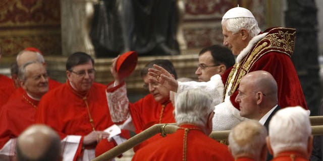 Feb. 18, 2012: Pope Benedict XVI, right, makes his way through cardinals as he arrives inside St. Peter's Basilica at the Vatican to preside over a consistory. Pope Benedict XVI is bringing 22 new Catholic churchmen into the elite club of cardinals who will elect his successor amid signs the 84-year-old pontiff is slowing down.