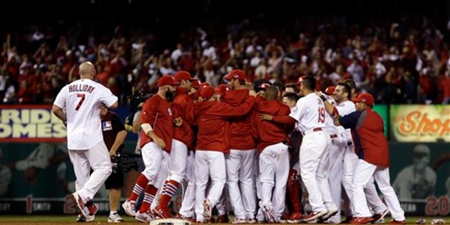 Oct. 12, 2013: St. Louis Cardinals' Carlos Beltran is mobbed by teammates after his game-winning hit during the 13th inning of Game 1 of the National League baseball championship series against the Los Angeles Dodgers in St. Louis.