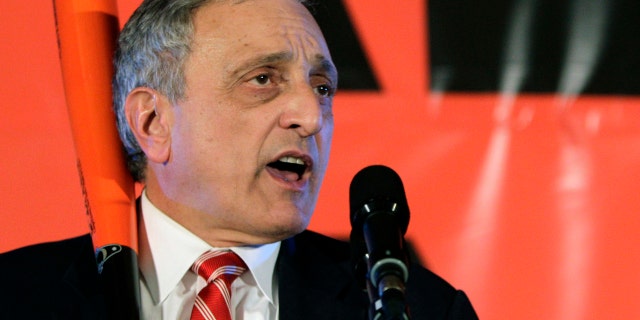 In this Nov. 2, 2010, file photo, Republican gubernatorial candidate Carl Paladino holds a baseball bat as he concedes the election in Buffalo, N.Y.