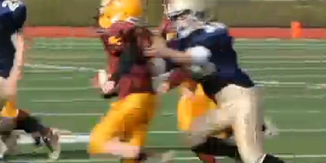 This undated screen shot shows Caroline Pla, right, making a tackle during a football game.