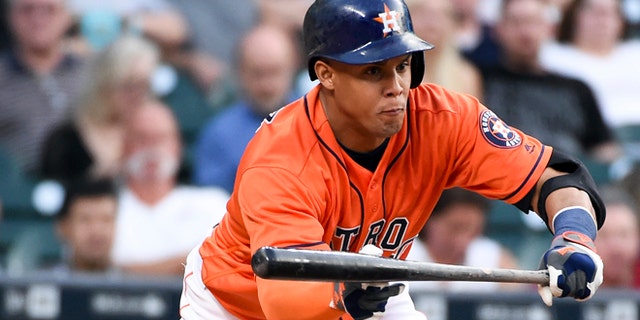 Houston Astros' Carlos Gomez bunts in the second inning of a baseball game against the Seattle Mariners, Friday, May 6, 2016, in Houston. (AP Photo/Eric Christian Smith)