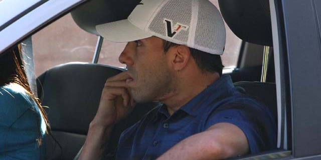 Sept. 28: Manchester City striker Carlos Tevez is driven away from his home in Cheshire, England. (AP Photo/ Dave Thompson/PA Wire)