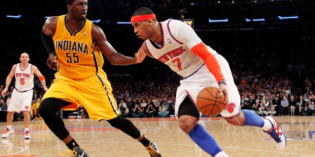 New York Knicks' Carmelo Anthony (7) drives past Indiana Pacers' Roy Hibbert (55) in the second half of Game 2 of their NBA basketball playoff series in the Eastern Conference semifinals at Madison Square Garden in New York, Tuesday, May 7, 2013. The Knicks won 105-79. (AP Photo/Mary Altaffer)