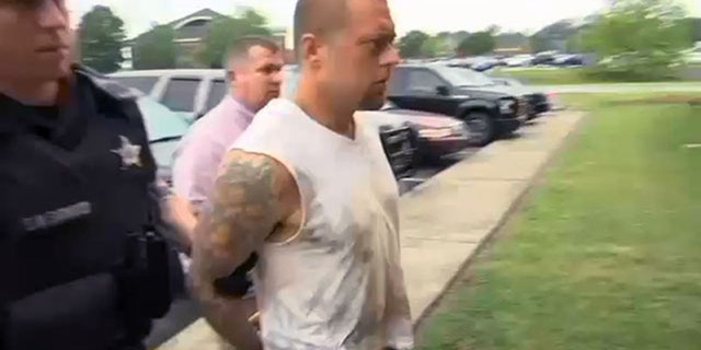 Zachary Powell being taken into custody