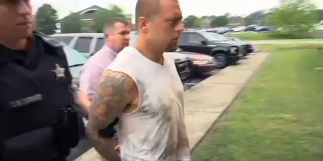 Zachary Powell being taken into custody
