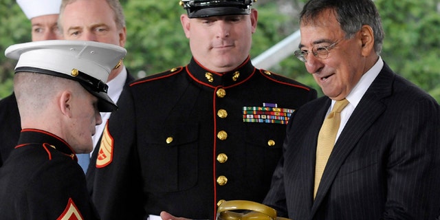 FILE: U.S. Defense Secretary Leon Panetta, right, handles the ceremonial scissors from U.S Marine Corps Lance Corporal Kyle Carpenter to cut the ribbon at the dedication ceremony at the Walter Reed National Military Medical Center in Bethesda.