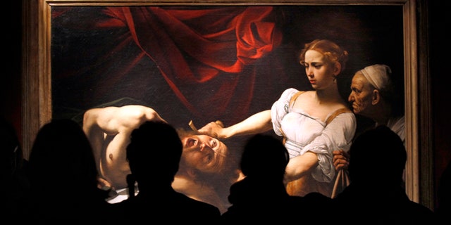 FILE 2010: Visitors stand near Caravaggio's "Judith Beheading Holofernes" painting during an exhibition to celebrate the Baroque master on the 400th anniversary of his death at the Scuderie del Quirinale building in Rome.