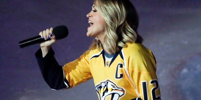 Carrie Underwood performs the national anthem before Game 3 of a first-round NHL hockey playoff series between the Predators and the Chicago Blackhawks Monday, April 17, 2017, in Nashville, Tenn.