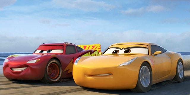 This image released by Disney shows Lightning McQueen, voiced by Owen Wilson, left, and Cruz Ramirez, voiced by Cristela Alonzo in a scene from "Cars 3." (Disney-Pixar via AP)