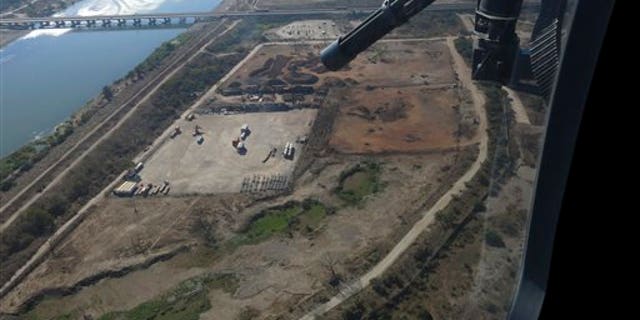 In this March 12, 2014, Mexican federal police fly over the Balsas River near the Pacific port of Lazaro Cardenas, Mexico. Alonso Ancira, president of the National Chamber of the Iron and Steel, told local media that drug cartels earned $1 billion in profits in 2013 from the sale of iron ore, according to his estimates. By 2012 nearly half of the iron ore exports to China went through the port of Lazaro Cardenas. The federal government took over the port of Lazaro Cardenas in November 2013. (AP Photo/Eduardo Castillo)