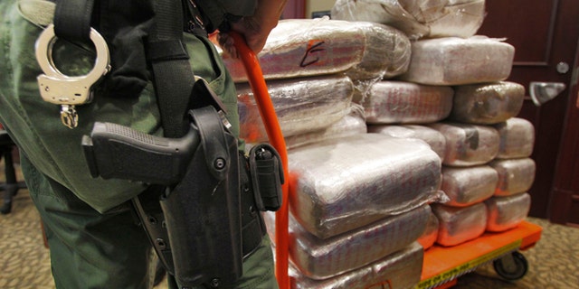 Nov. 4, 2010: In this file photo, bales of marijuana are wheeled out at a news conference in Jonesboro, Ga. Forty-five people were arrested 45 people along with cash, guns and more than two tons of drugs as part of an investigation by federal and local law enforcement into the Atlanta-area U.S. distribution hub of Mexico's La Familia drug cartel.