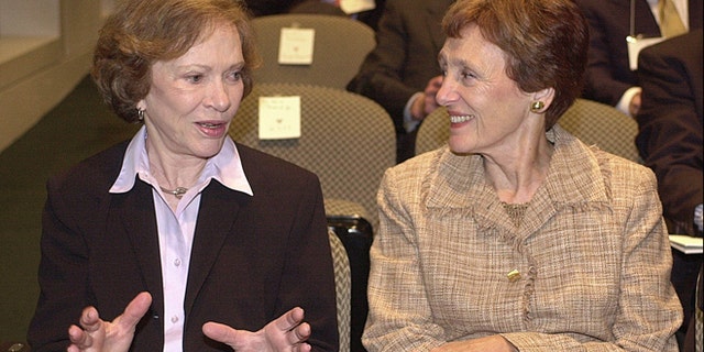 Sept. 17, 2003: Former first lady Rosalynn Carter, left, and wife of former Vice President Walter Mondale, Joan Mondale, chat prior to the opening of a symposium for the 25th anniversary of the Camp David peace accords between Israel and Egypt.