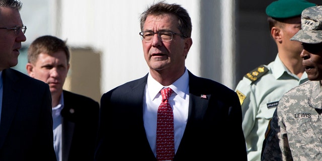July 23, 2015: U.S. Defense Secretary Ash Carter, joined by U.S. Army Lt. Gen. Ron Lewis, right, and Chief of Staff Eric Rosenbach, left, walks the tarmac before boarding his plane at Queen Alia Airport in Amman, Jordan, en route to Baghdad, Iraq.