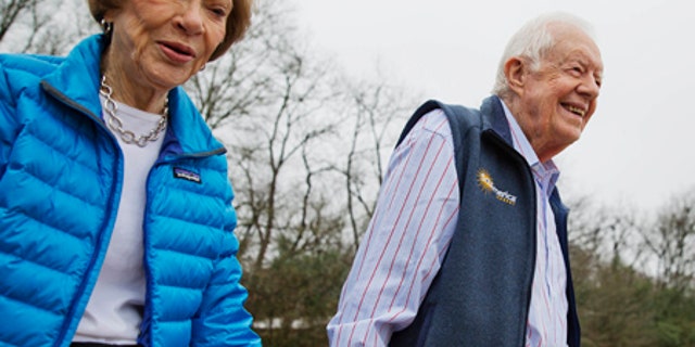 Former President Jimmy Carter and his wife Rosalynn arrive for a ribbon cutting ceremony for a solar panel project on their Georgia farm