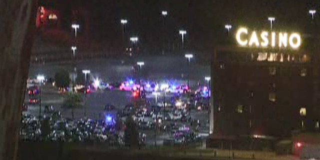 Three gunmen with assault rifles barged into Casino Queen and robbed the cash cage, police said. A security guard was also shot.