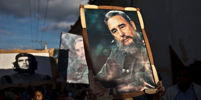 Jan. 8, 2015: Children carry framed images of Fidel Castro and Che Guevara in a caravan tribute marking the 56th anniversary of the original street party that greeted a triumphant Castro and his rebel army.