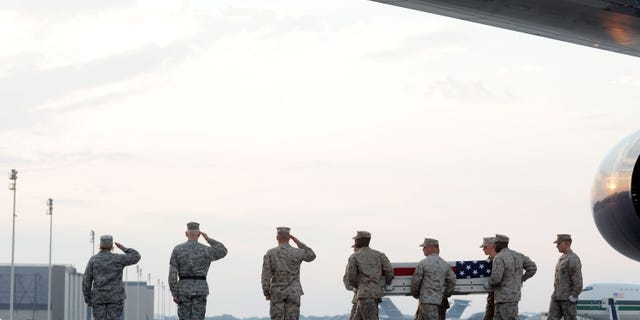 Aug. 9: A Marine carry team moves a transfer case containing the remains of Sgt. Adan Gonzales Jr. at Dover Air Force Base, Del. According to the Department of Defense, Gonzales, 28, of Bakersfield, Calif., died Aug. 7, 2011 while conducting combat operations in Helmand province, Afghanistan.