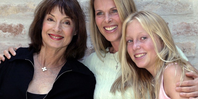 Member of Serbia's royal family Princess Jelisaveta Karadjordjevic (L) poses for a picture with her daughter U.S. actress Catherine Oxenberg (C) and grand daughter India (R) at her home in Belgrade's suburb of Zemun June 11, 2004.